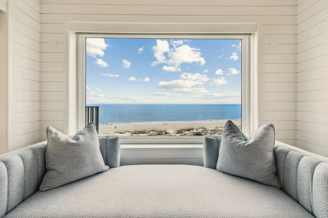 Cushioned window seat looking out over the beach and the sea
